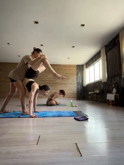 A private session is about partnership. Here, I am providing a hands-on adjustment to help a student safely deepen their pose. This is where the real work happens, with undivided attention and guidance that helps you understand the mechanics of your own body and move past your perceived limits.