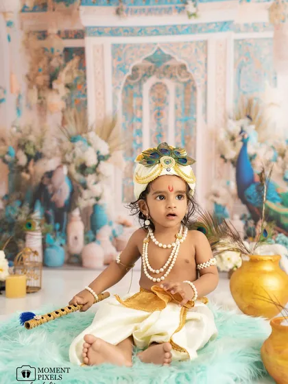 I adore bringing creative visions to life. This little one dressed as Krishna for a Janmashtami themed shoot, complete with a flute and an ornate backdrop, shows the beautiful, detailed, and cultural stories we can tell together.