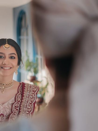 The moment he sees her. Her radiant smile and glowing makeup make this first look absolutely unforgettable.