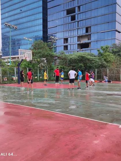 A wide view of our rainy day practice. The wet court doesn't stop our players from working on their skills and having fun.