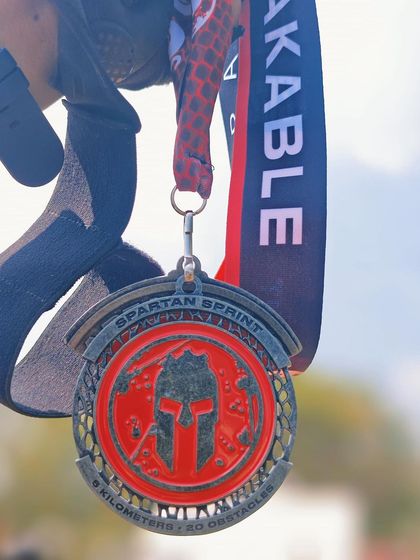 A detailed look at the Spartan Sprint medal. 5 kilometers and 20 obstacles conquered. We help runners of all levels prepare for and complete challenges like this.