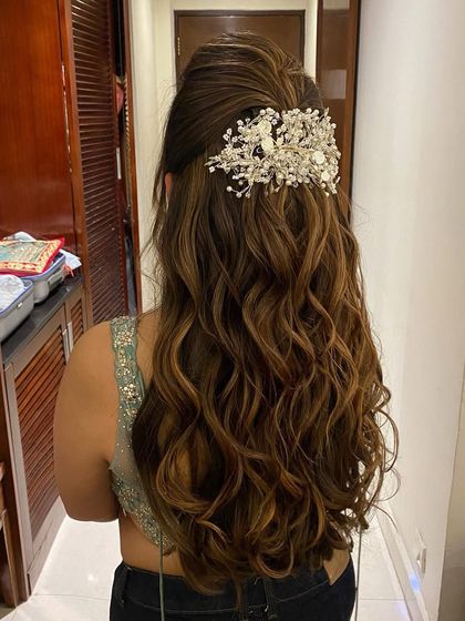 Accessorizing messy looks is my favorite. This half-up style with messy waves is elevated with a beautiful, large hair accessory.