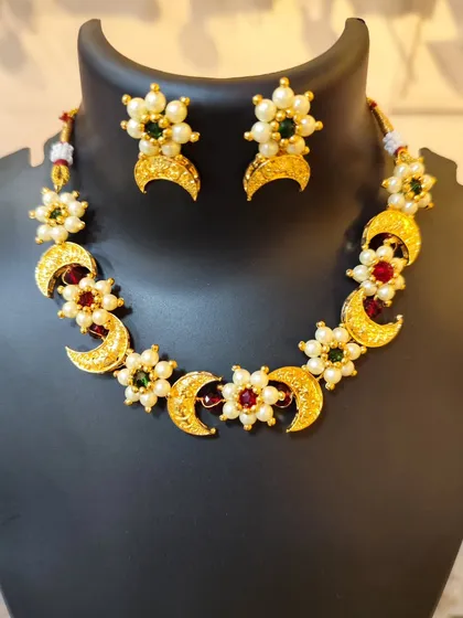 A beautiful Chandrahaar with multi-colored stones and pearls, a very festive piece.