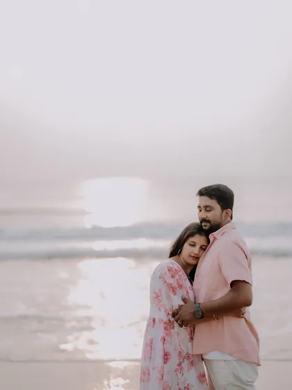 A gentle embrace during sunset on the beach. The soft, warm light of the golden hour creates a beautifully romantic and intimate atmosphere.