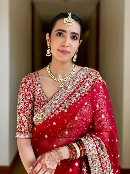 A picture-perfect day for my beautiful bride Khushboo. Her red saree and soft, natural makeup created a look of pure elegance.