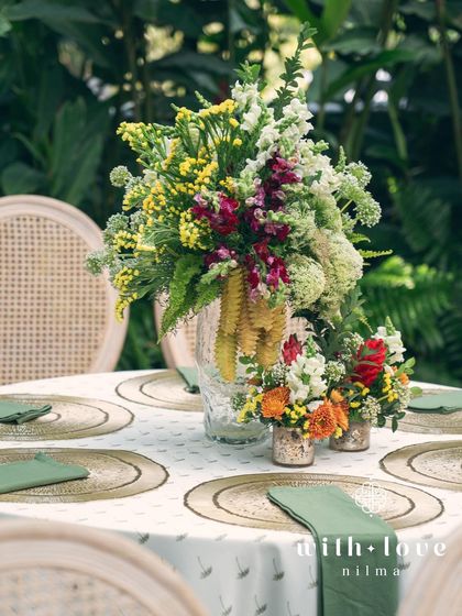 A tablescape detail from the 'Garden of Gaia' event, with a mix of tropical and classic flowers.