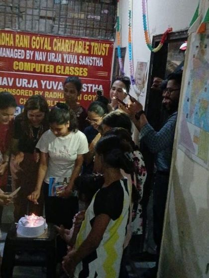 A cake cutting ceremony with the children and teachers. These moments of celebration are an important part of building a supportive and positive community environment.