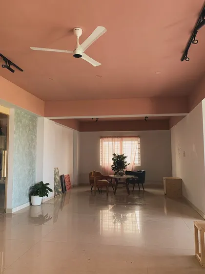 Our co-working and event space, ready for your next project or gathering. The warm tones and open layout make it a versatile and inviting area.