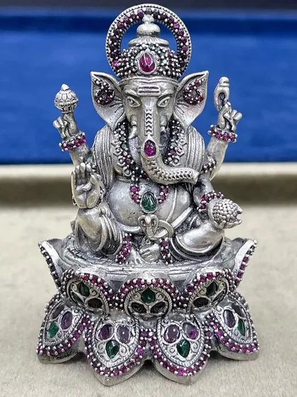 A detailed view of our stone-adorned Lord Ganesh murti. The fine work on the trunk, ears, and the modak in his hand reflects our commitment to quality and authenticity in our religious artefacts.