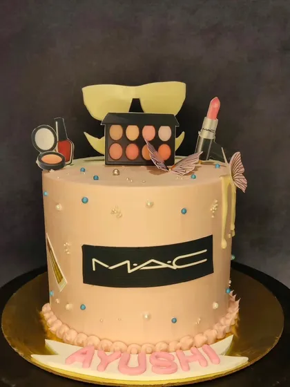 A cake for the makeup lover, themed around MAC Cosmetics. This cake is topped with edible replicas of lipstick, eyeshadow palettes, and nail polish, all crafted with precision.