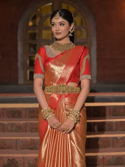 A full-length view of the bride, her traditional attire looking stunning against the evening light.