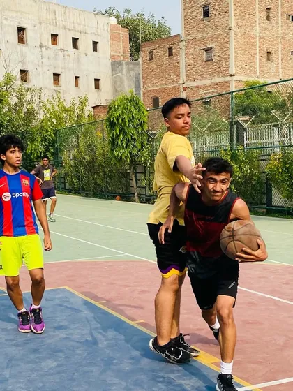A player dribbles up the court while a teammate sets a screen. We teach offensive concepts like the pick-and-roll to create scoring opportunities.