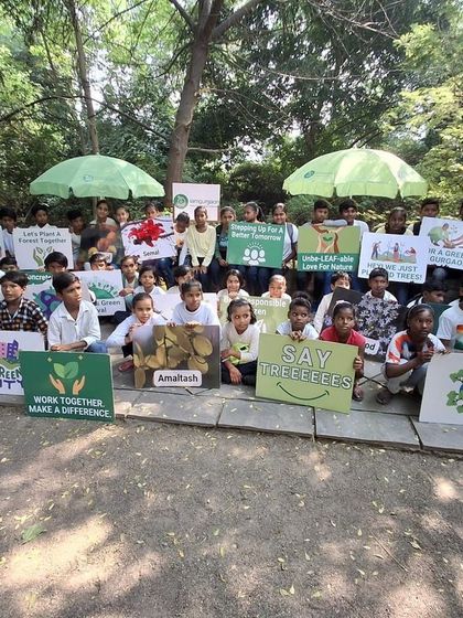 The proud students of Free Paathshala pose with their environmental signs after a morning of learning and exploration at our restored site.
