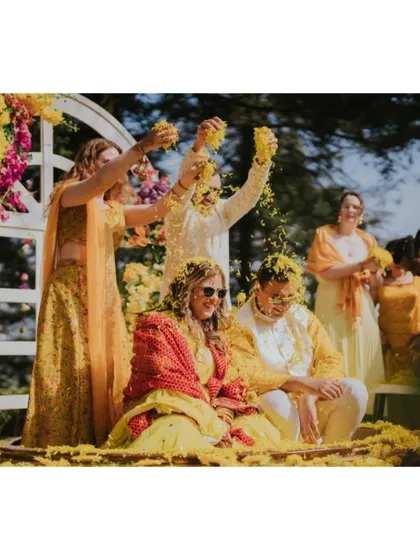 The moment of pure joy as the couple is showered with marigold petals by their loved ones. We design our Haldi setups to be interactive and full of energy.