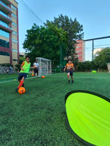 An Under 8 player showing great focus as he dribbles towards the goal during a training exercise.
