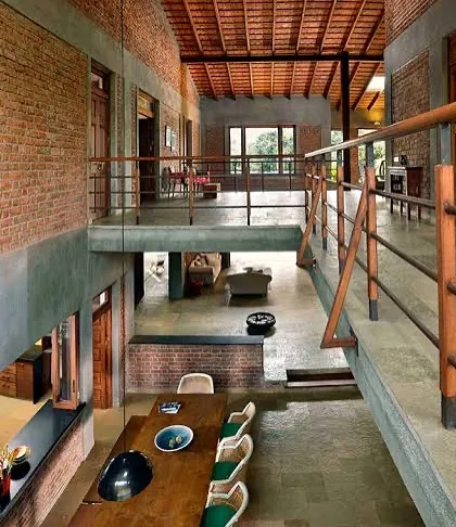 The multi-level interior of The Mango House. The open-plan design connects the dining area on the ground floor with the living spaces above, creating a dynamic and social atmosphere within the home.
