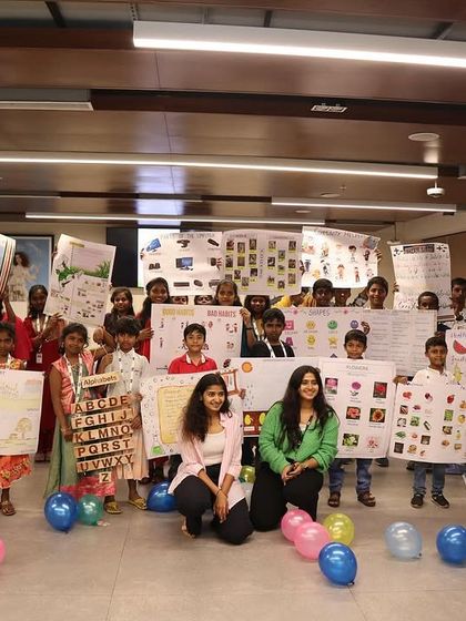 The full group from the Hudson's Bay workshop, holding up charts and art they created. It was a day of learning and creativity.
