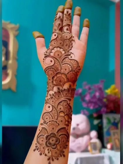 A full-hand Arabic fusion design. The pattern covers the hand and wrist with flowing floral and paisley motifs, offering a dense look that is still very modern.