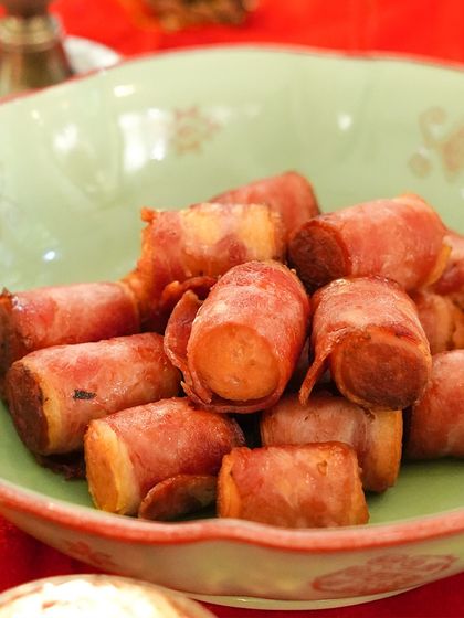 A bowl of our classic pigs in a blanket, a crowd-pleasing favorite at festive events. These savory bites are perfect for passing around at a cocktail party or as part of a larger buffet.