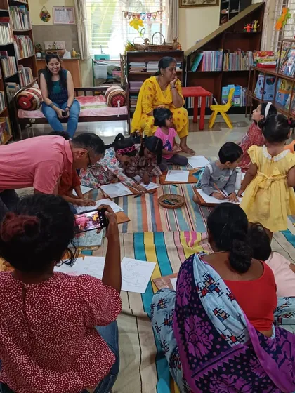 Children and parents work together on a drawing activity after a story about sea animals. Our workshops are a great opportunity for family bonding and collaborative creativity.