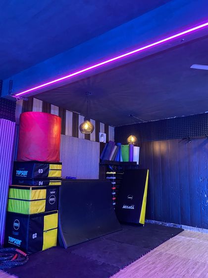 This is our gymnastics corner, fully equipped with stacked plyo boxes, a vaulting horse, and soft mats to ensure safe and effective training.