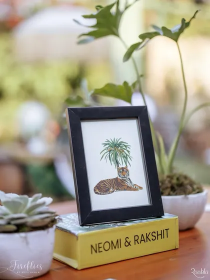 A custom-illustrated tiger graphic in a simple frame, part of the many small details that built the narrative of the safari theme.