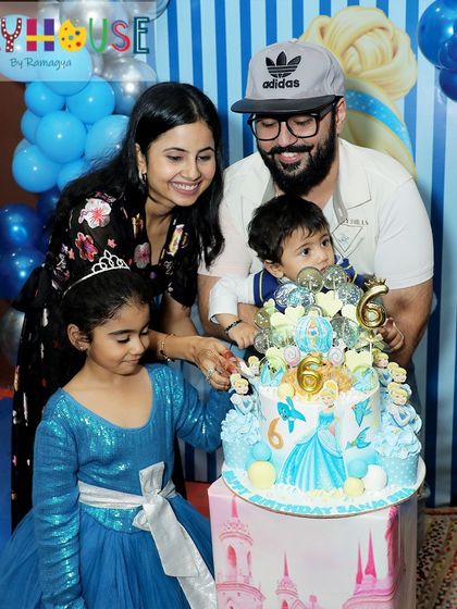 The cake cutting at Sanaisha's Cinderella party was a joyous family affair, celebrating her 6th birthday with a beautiful themed cake.