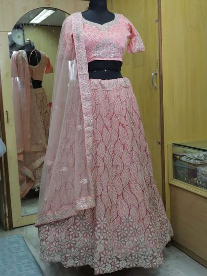 A delicate pastel pink lehenga with tone-on-tone leaf pattern embroidery. This is a subtle and elegant choice for a daytime event.
