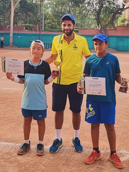 Two more young champions with their coach. We are building a strong foundation for the future of tennis.