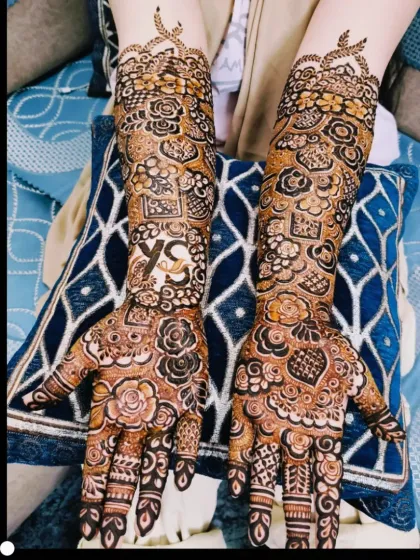 A lovely bridal design with the couple's initials 'YS' placed prominently on the back of the hands.