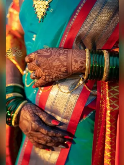 Another close-up of the bride's hands, showing the peacock design on the back of her hand. The rich color and fine details are clearly visible.