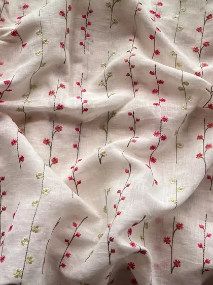 This white embroidered linen with delicate red and yellow floral sprigs is the epitome of simple, subtle, and stunning. Perfect for a summer kurta.