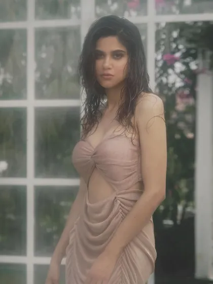 A direct and captivating gaze from Aaditi Pohankar. The sultry, wet-look makeup enhances her features and adds to the overall moody and atmospheric feel of the shoot.