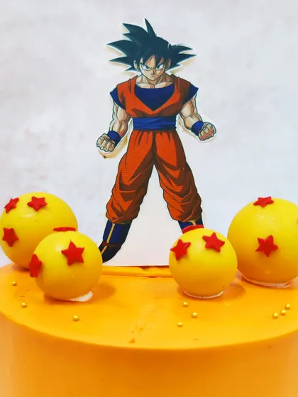 A close-up on the Goku topper and the meticulously crafted Dragon Balls, each with its signature red stars.