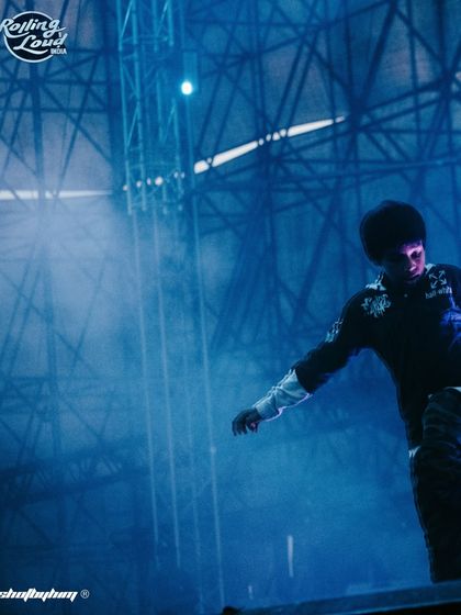 A fan's perspective of the stage during Rich the Kid's set, with blue smoke filling the air. This captures the immersive atmosphere of being in the crowd.