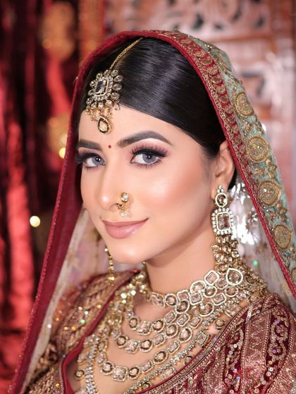 A soft and subtle bridal look. The makeup is understated and elegant, with a nude lip and gentle contouring, perfect for a bride who prefers a natural style.