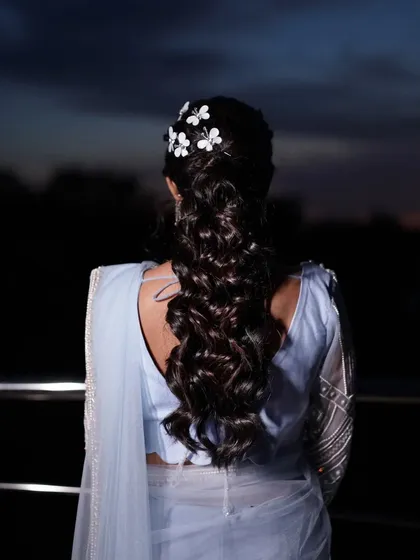 A view of the bride's beautiful hairstyle from the back, adorned with delicate white butterfly clips. This shows that we consider every detail of the look.