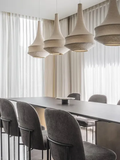This dining area from House 111 showcases our approach to minimalist design. The monochromatic palette is warmed by the texture of the woven pendant lights and the subtle grain of the chairs. It’s a space that feels composed and elegant, proving that simplicity can be incredibly rich and inviting.