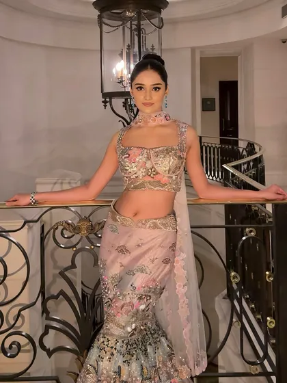 A full-length shot of the bride on a grand staircase, looking like a modern princess.