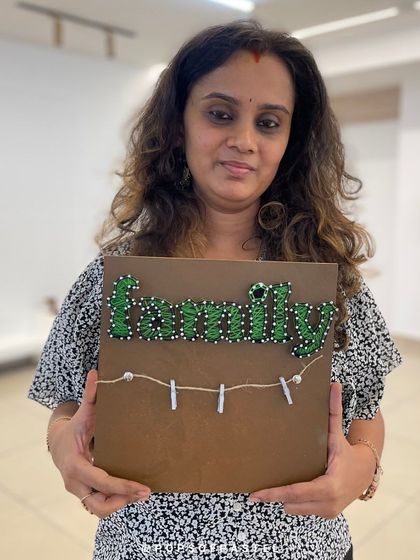 This participant created a beautiful "Family" string art piece with green string, perfect for adding a touch of handmade charm to her home.