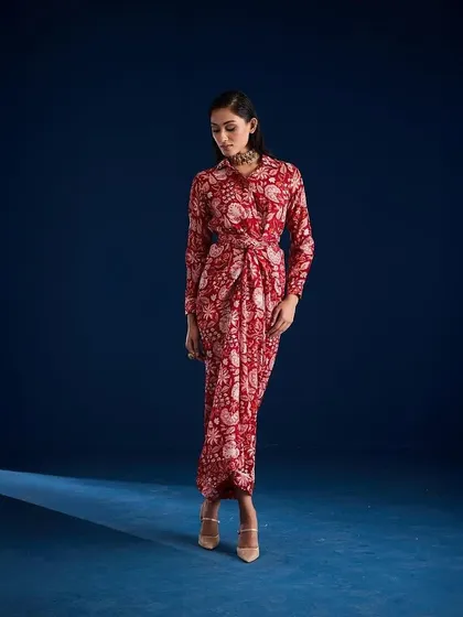 A three-quarter view of the Aapro Rosela Draped Skirt Set, capturing a thoughtful and elegant pose.