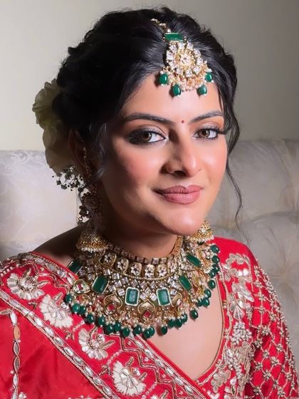 A beautiful portrait of Kritika. Her makeup is soft and elegant, allowing her natural beauty and the vibrant colors of her outfit to shine.