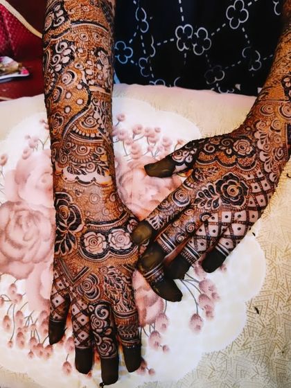 The complete bridal mehndi for Farheen, showing the detailed work on her hands and feet, and the beautiful final stain.