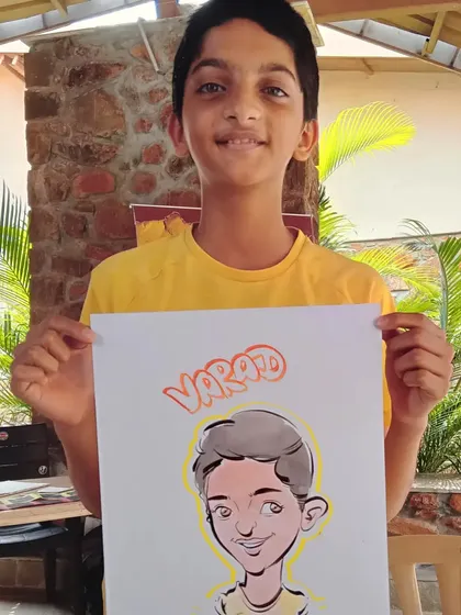 This young man, Varad, is all smiles with his personalized caricature. A great keepsake from a family gathering.