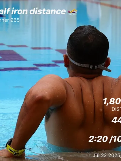 A half-Ironman distance swim of 1,800 meters. This photo captures a moment of rest, showing the physical strength required for long-distance swimming.