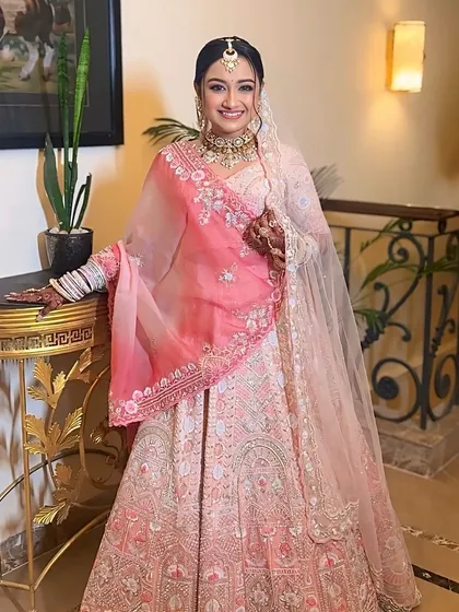 A beautiful bride ready for her pheras in a stunning pink and white lehenga. We created a minimal, radiant look to enhance her natural glow.