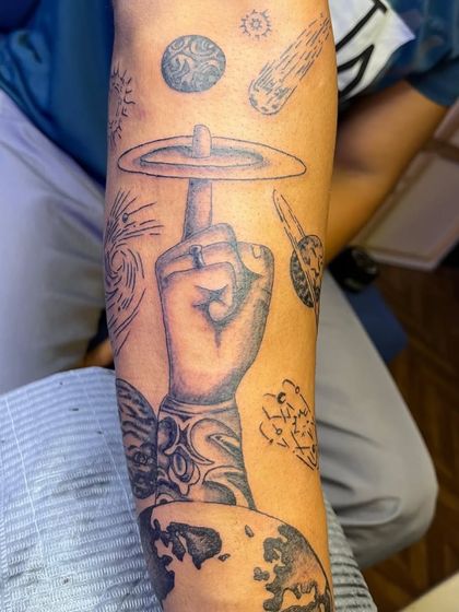 A detailed shot of the upper part of the cosmic sleeve. You can see the fine line work used for the sun and stars, contrasted with the shaded planets.