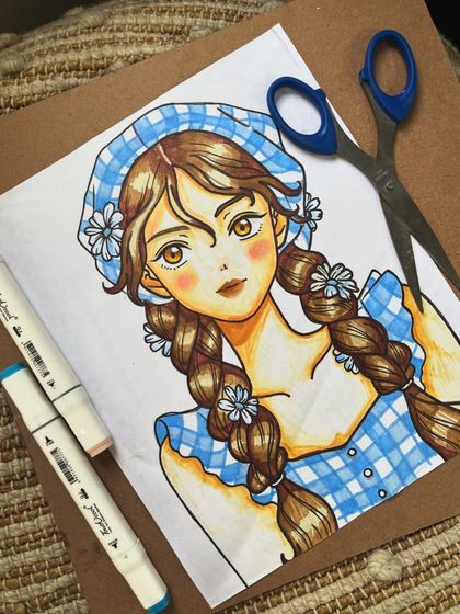 An adorable anime-style character drawn with alcohol markers. We explore various styles and mediums in our classes to help students find their artistic voice.