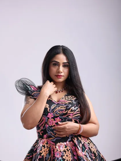 A different pose in the same floral gown, showcasing its versatility for creating various moods, from sweet to sultry.