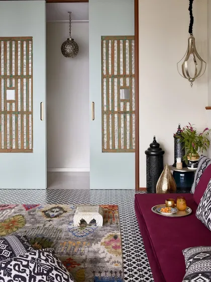 This versatile family room is designed for connection and reflection. The large sliding doors are the centerpiece, crafted from old Portuguese Goan shell panels that filter light beautifully. By repurposing these historic elements, we’ve woven a piece of Goan architectural heritage into a modern Mumbai home.